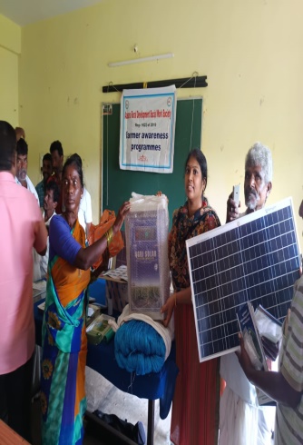 Farmers receiving a solar panel and fence energiser